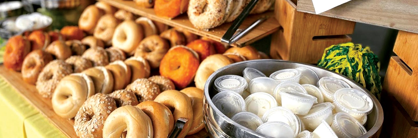 Photo of variety of bagels with cream cheese.