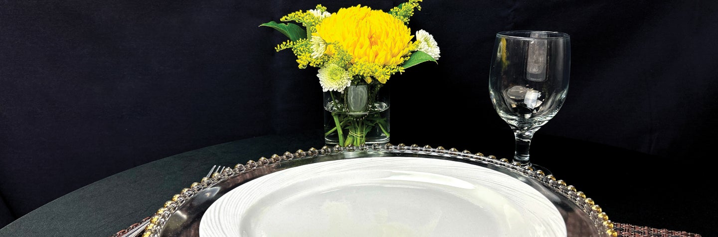 Photo of serving plate and flower and glassware.